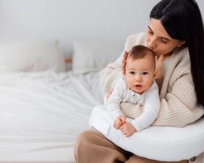 side-view-mother-holding-newborn-baby_23-2150227205