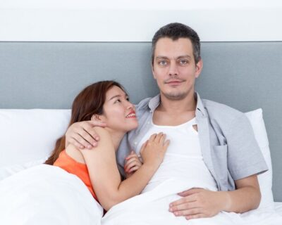 smiling-couple-embracing-lying-bed_1262-5646